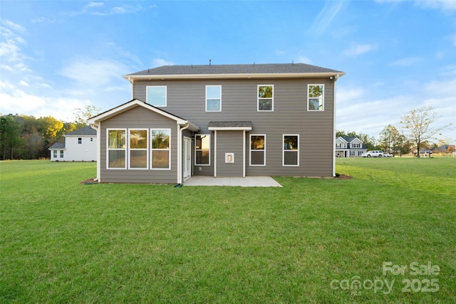 rear view of property with a patio and a yard