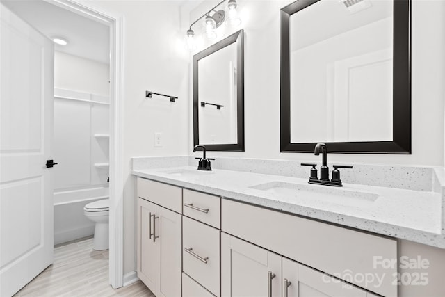 full bathroom featuring shower / tub combination, vanity, and toilet