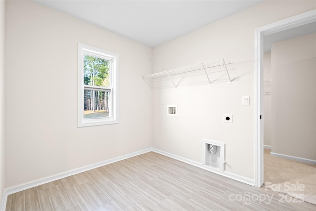 washroom with hookup for a washing machine and hookup for an electric dryer