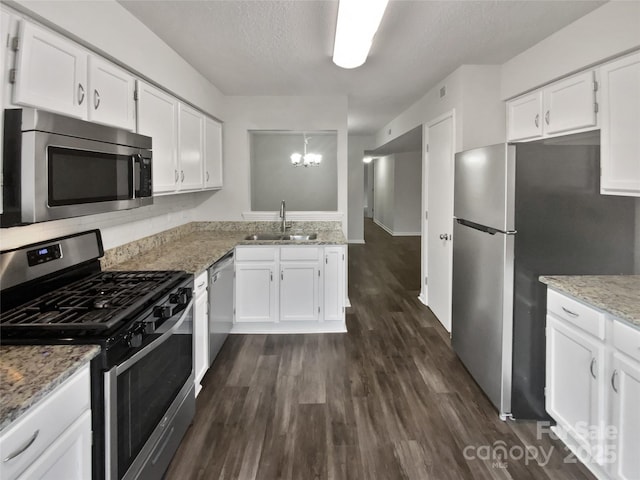 kitchen with sink, stainless steel appliances, dark hardwood / wood-style floors, and white cabinetry