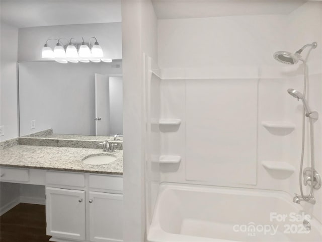 bathroom with shower / bathing tub combination, wood-type flooring, and vanity