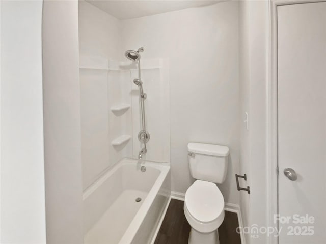 bathroom featuring wood-type flooring, shower / bathing tub combination, and toilet