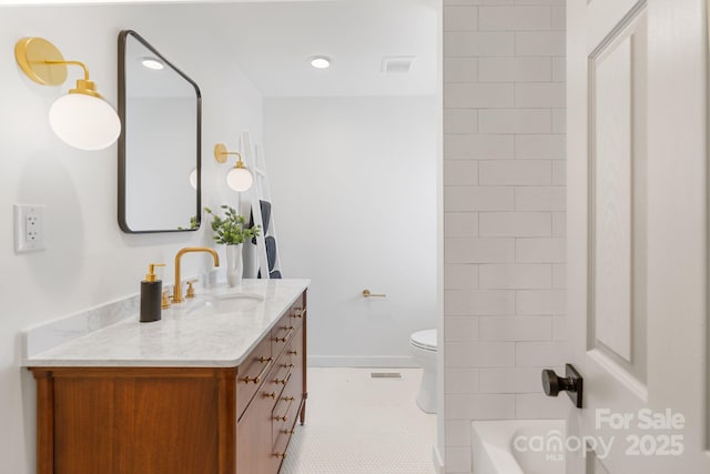 bathroom featuring tile patterned floors, toilet, and vanity