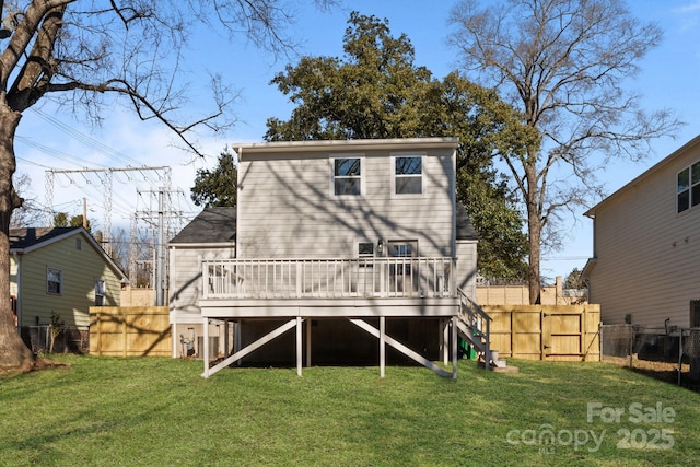 back of property with a wooden deck and a yard