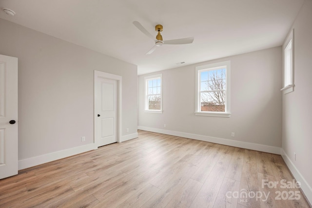 unfurnished bedroom with light wood-style flooring, a ceiling fan, and baseboards