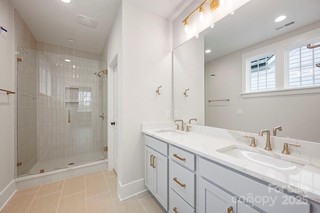 bathroom featuring a stall shower, visible vents, and a sink