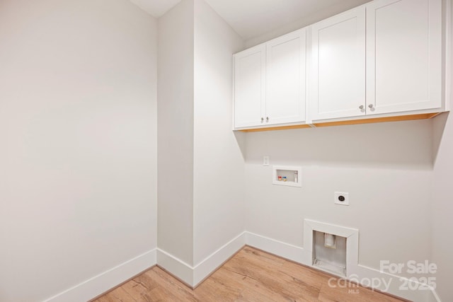 laundry area with electric dryer hookup, cabinet space, light wood finished floors, baseboards, and hookup for a washing machine