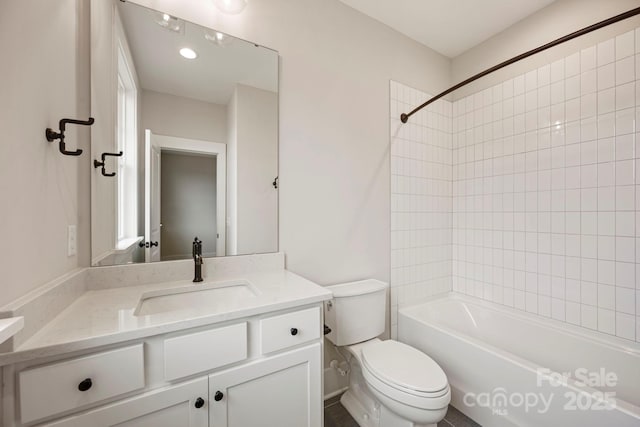 bathroom with toilet, shower / washtub combination, and vanity