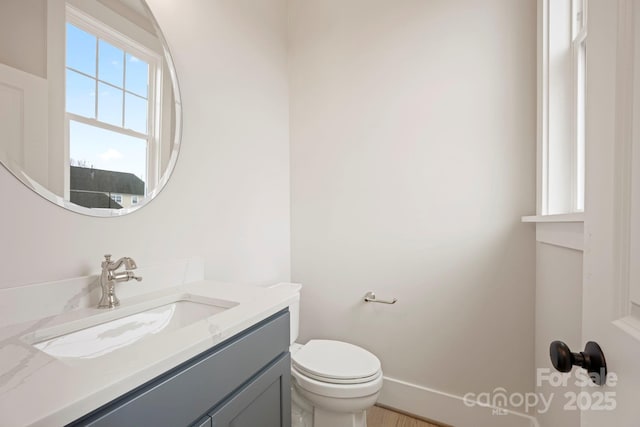 half bath featuring toilet and vanity