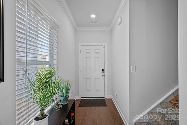 doorway to outside with ornamental molding and hardwood / wood-style flooring