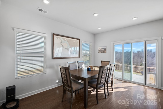 dining area featuring dark hardwood / wood-style flooring and a healthy amount of sunlight