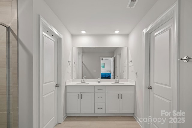 bathroom featuring vanity and an enclosed shower