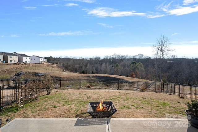 view of yard with a fire pit