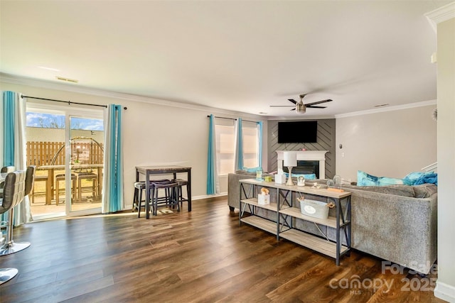 living room with ornamental molding, dark hardwood / wood-style floors, and ceiling fan