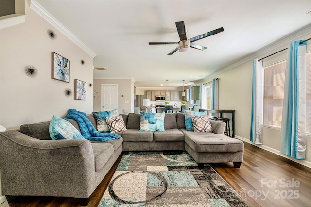 living room with ornamental molding, dark hardwood / wood-style floors, and ceiling fan