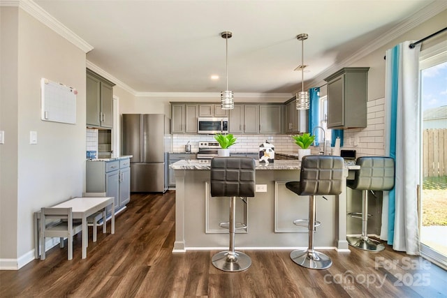 kitchen with gray cabinetry, stone countertops, hanging light fixtures, dark hardwood / wood-style flooring, and stainless steel appliances