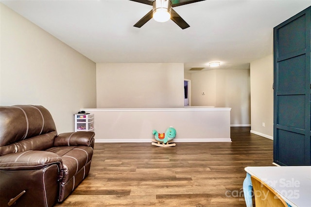 sitting room with hardwood / wood-style flooring and ceiling fan