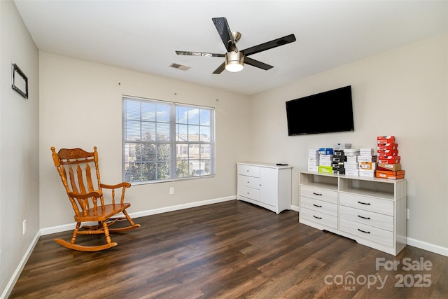 sitting room with dark hardwood / wood-style flooring and ceiling fan