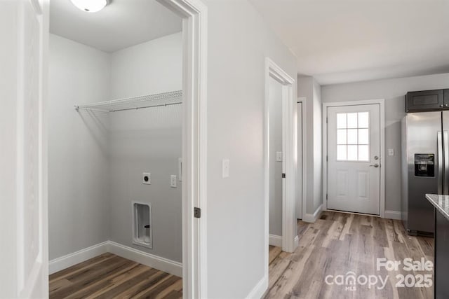 clothes washing area featuring light hardwood / wood-style floors and hookup for an electric dryer