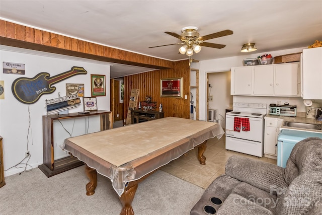 kitchen featuring sink, white cabinetry, pool table, wood walls, and white electric range