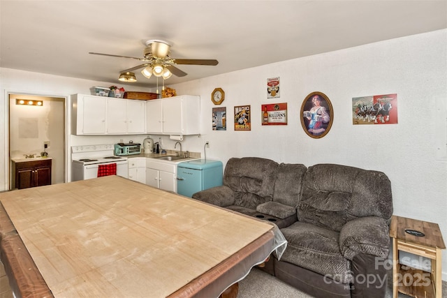 kitchen with sink, white cabinets, electric stove, and ceiling fan