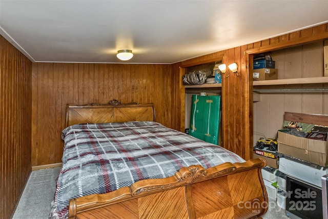 bedroom featuring wooden walls and carpet flooring