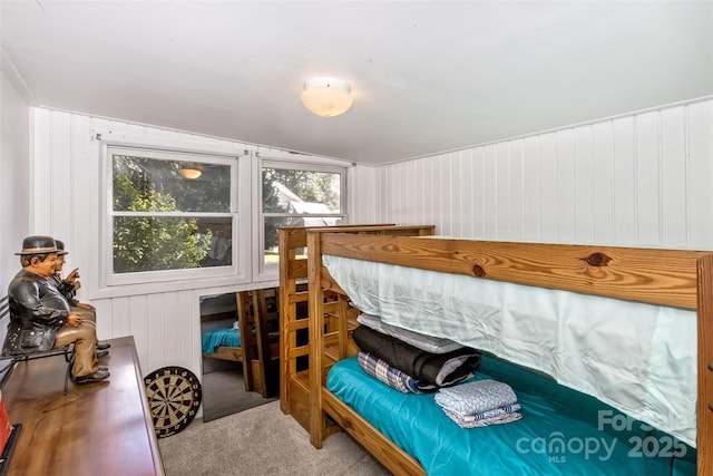 carpeted bedroom with lofted ceiling