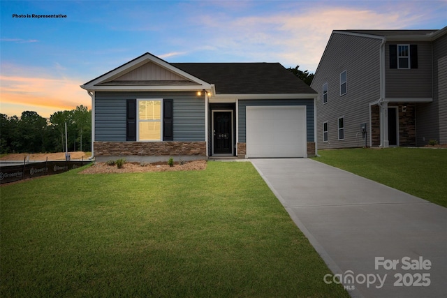 view of front of property with a yard and a garage