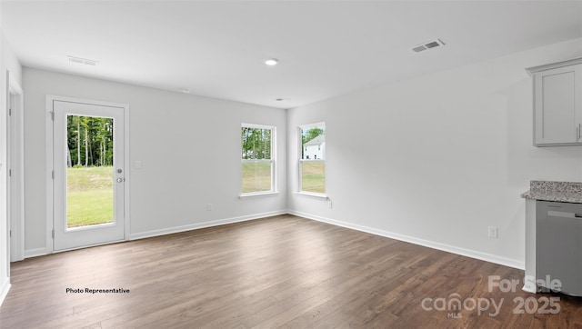 unfurnished dining area featuring dark hardwood / wood-style flooring