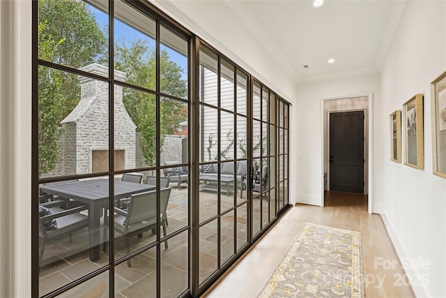 hall featuring hardwood / wood-style floors and ornamental molding