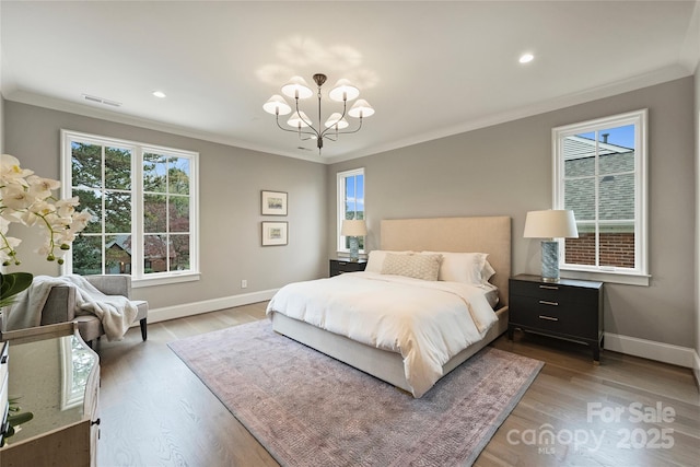 bedroom featuring ornamental molding, a chandelier, and wood-type flooring