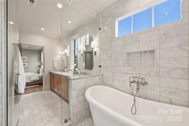 bathroom featuring a tub to relax in and vanity