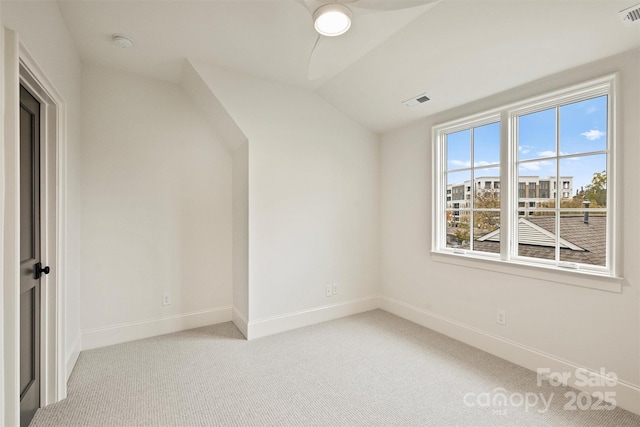 interior space with lofted ceiling and light carpet