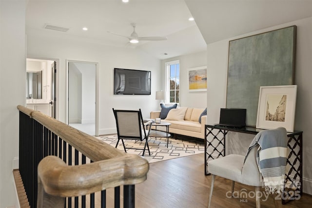 living room with vaulted ceiling, ceiling fan, and hardwood / wood-style flooring