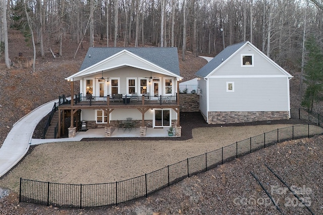 rear view of house with a patio and ceiling fan