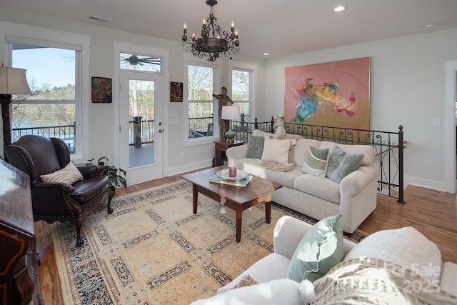 living room with a notable chandelier and hardwood / wood-style flooring