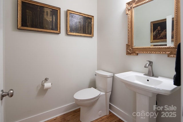 bathroom with wood-type flooring and toilet