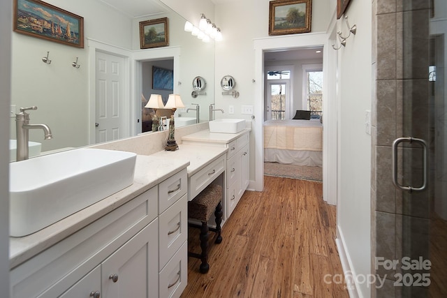 bathroom featuring vanity, wood-type flooring, and walk in shower