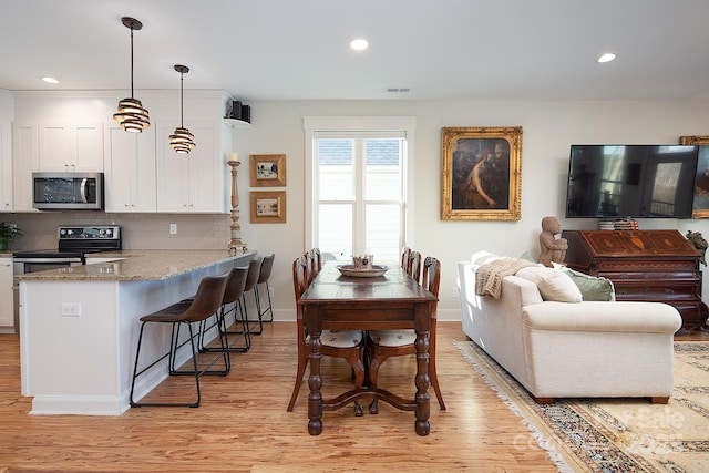 dining room with light hardwood / wood-style floors