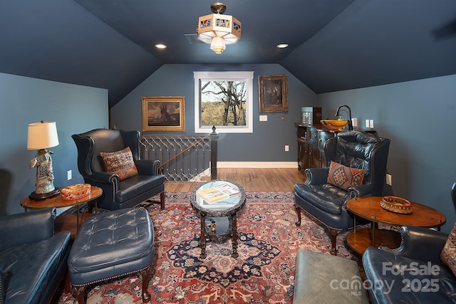 sitting room with lofted ceiling and light wood-type flooring