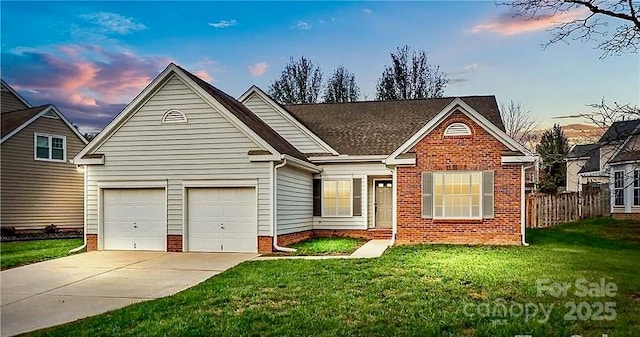 view of front of home featuring a lawn and a garage