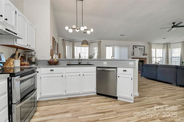 kitchen with pendant lighting, white cabinetry, sink, kitchen peninsula, and stainless steel appliances