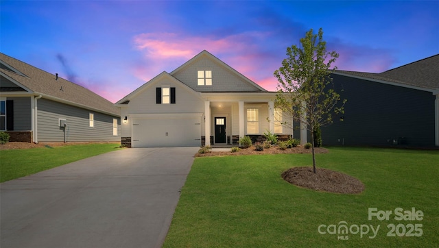 front of property with a yard and a garage