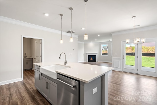 kitchen with dishwasher, pendant lighting, a center island with sink, gray cabinets, and sink