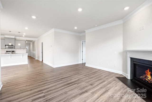 living room featuring ornamental molding and wood-type flooring