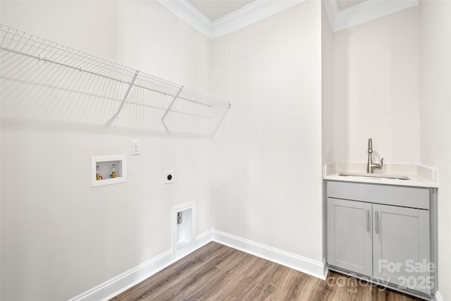 washroom featuring cabinets, hookup for an electric dryer, crown molding, washer hookup, and sink