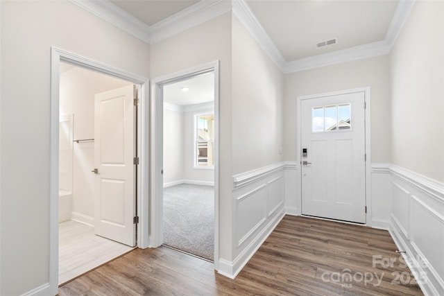 foyer featuring crown molding and wood-type flooring