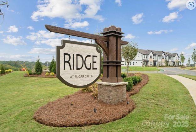 community / neighborhood sign with a lawn