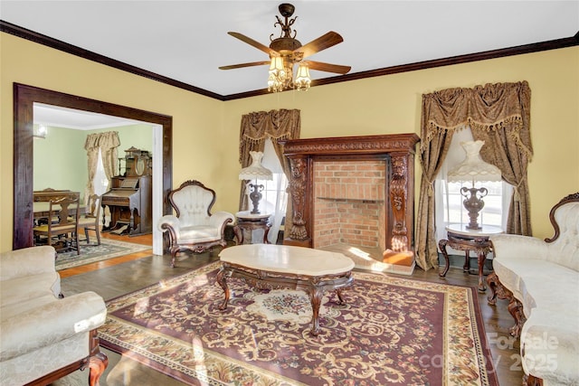 living room featuring ceiling fan, wood-type flooring, and ornamental molding