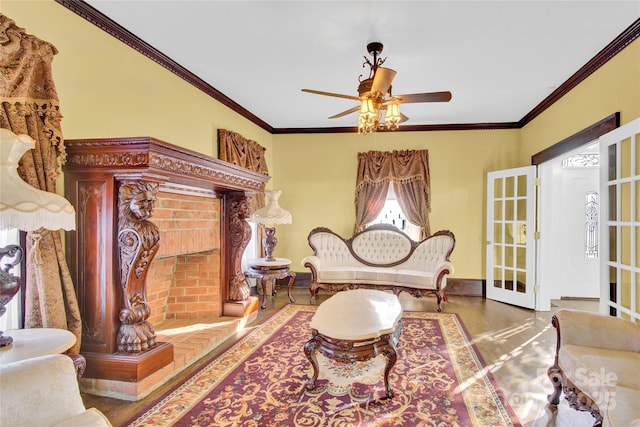 sitting room featuring ceiling fan, crown molding, and french doors